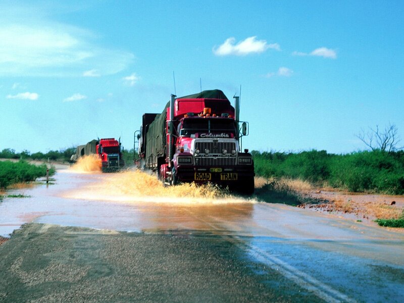 Trucks driving through flooded road