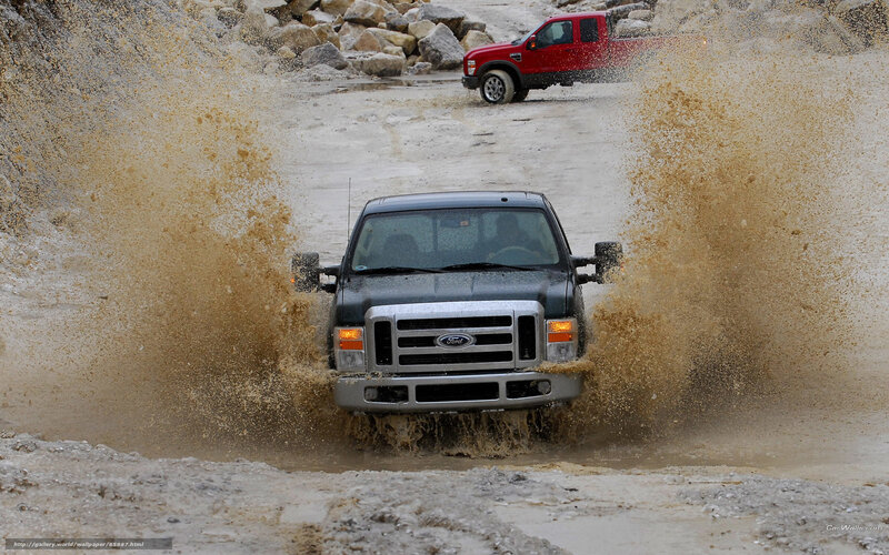 Trucks splashing through mud