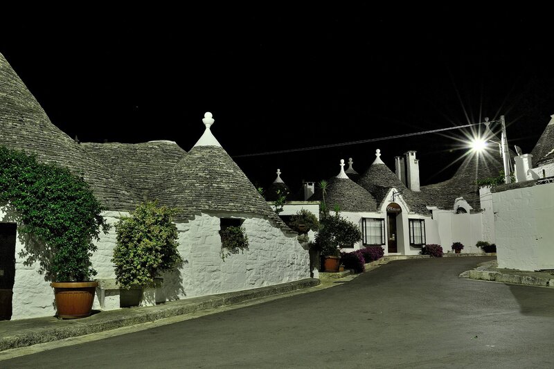 Trulli houses at night in Alberobello
