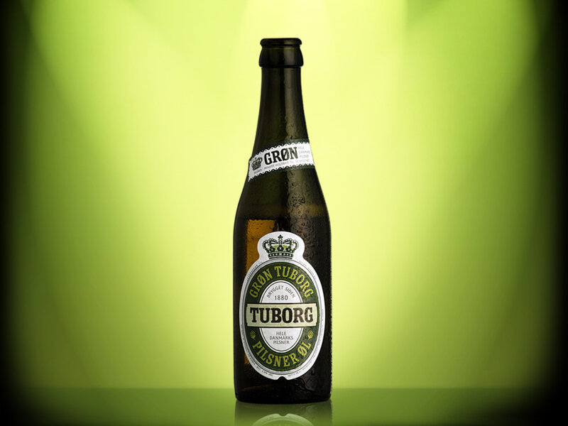 Tuborg beer bottle on green