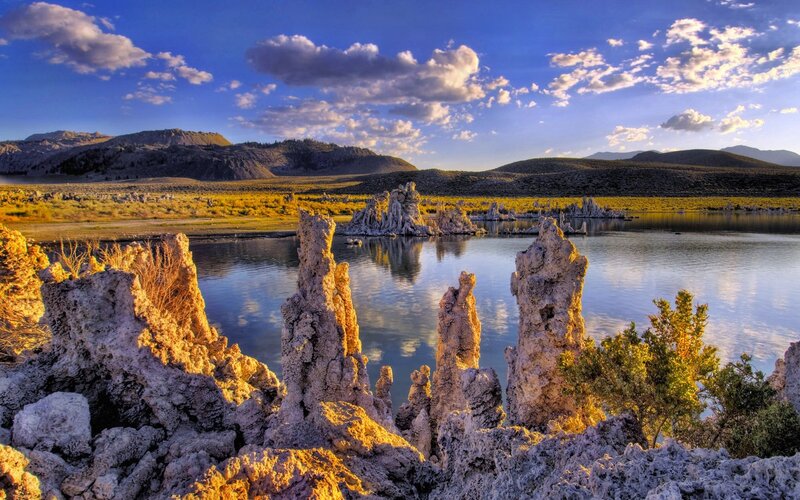 Tufa Formations in Lake — Blue, Serene, Sunset, Photograph, Mountains, Clouds, Vegetation, Yellow, Gray