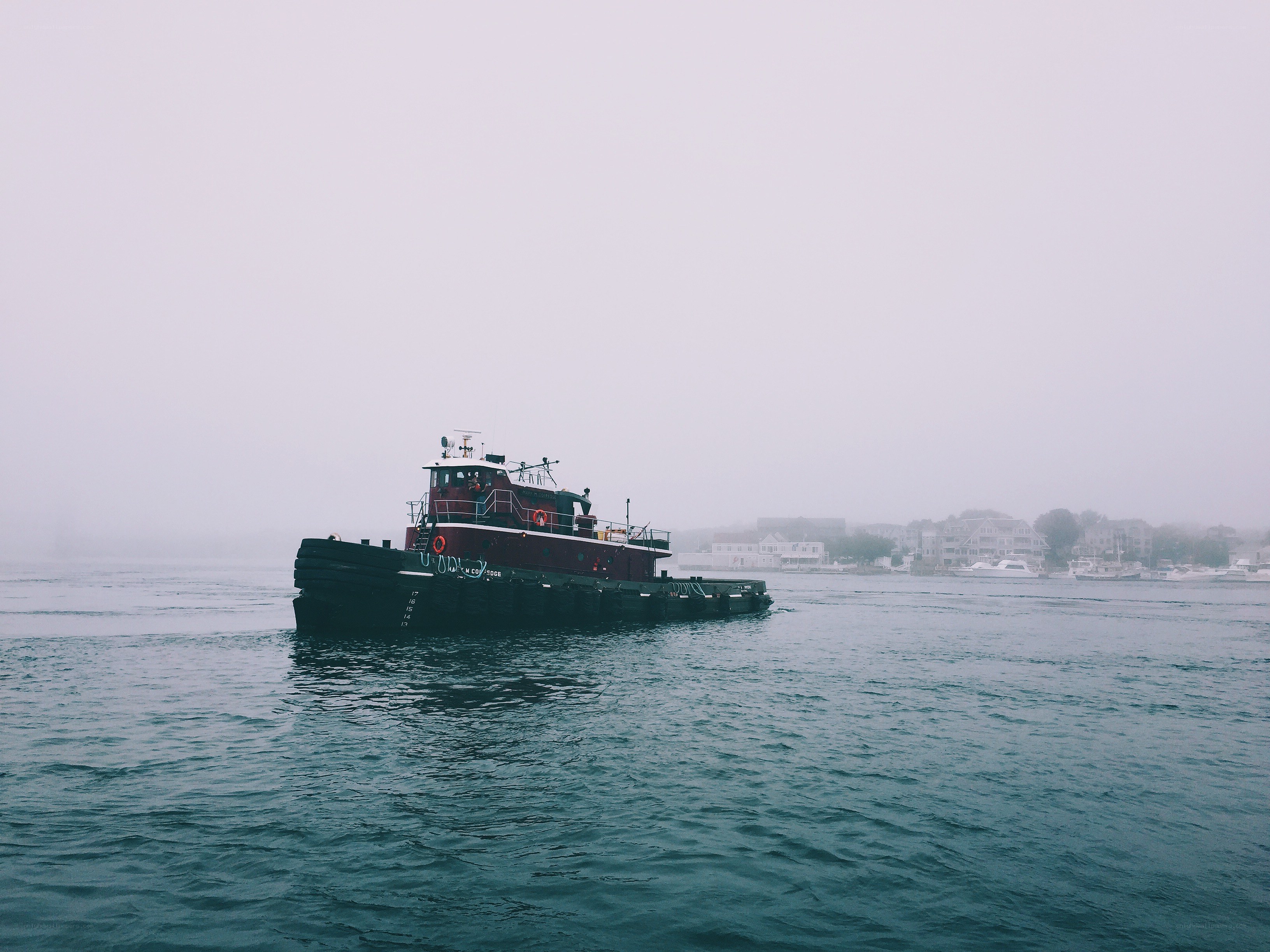 tugboat in foggy harbor