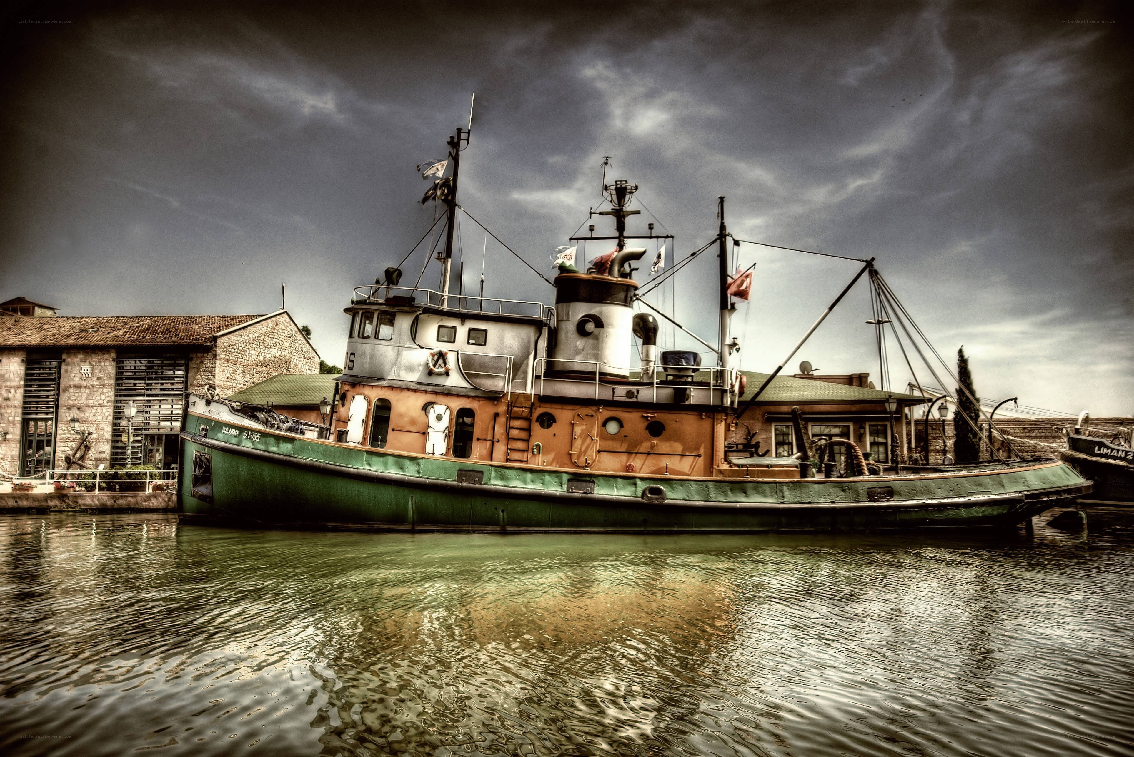 tugboat in harbor under cloudy sky