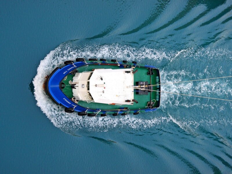 tugboat navigating blue water