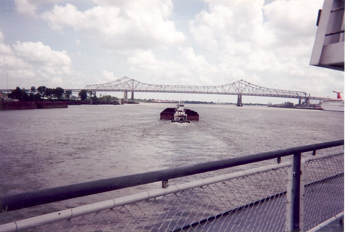 tugboat on a river with bridge