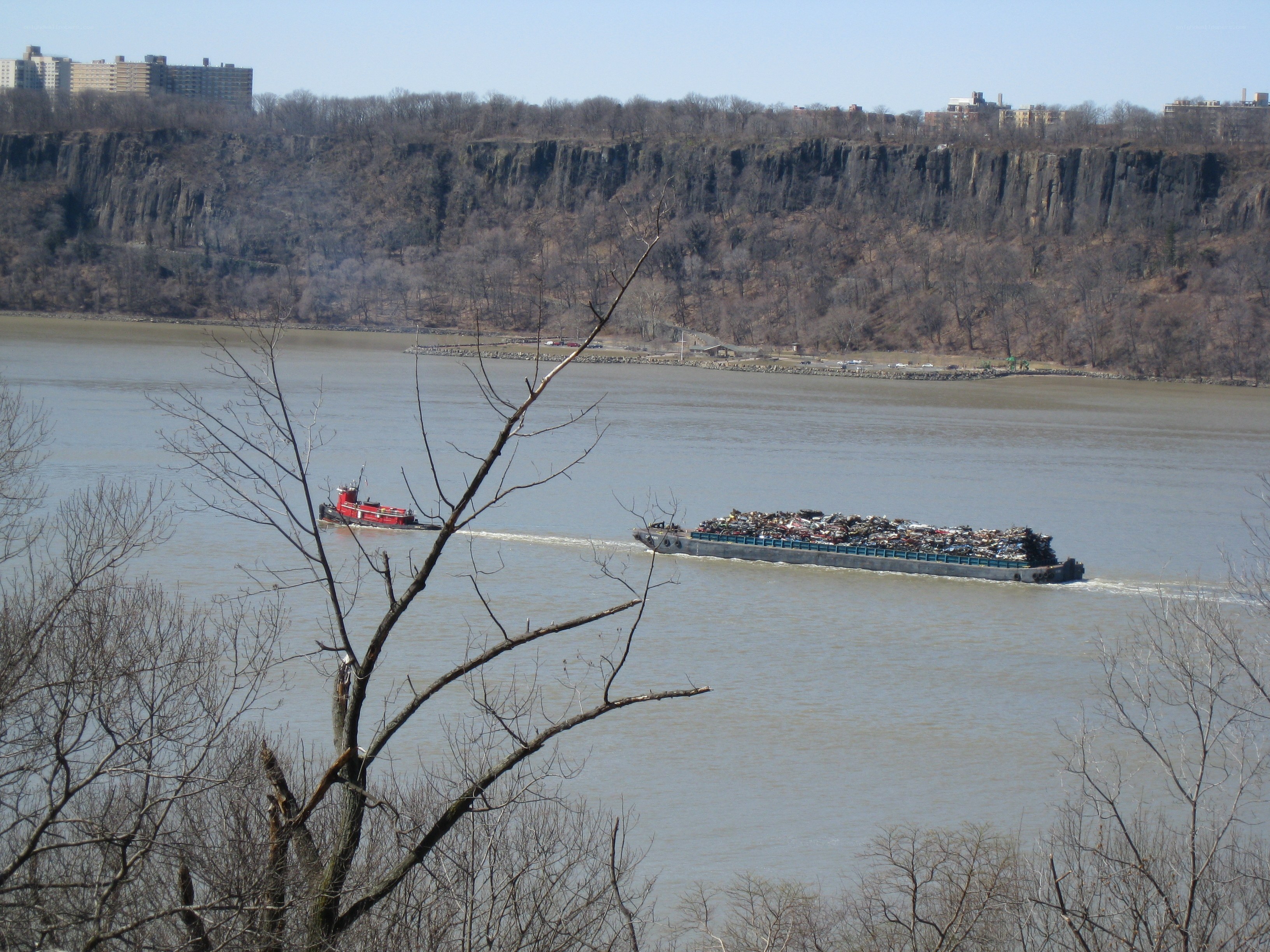 Tugboat pulling barge on river