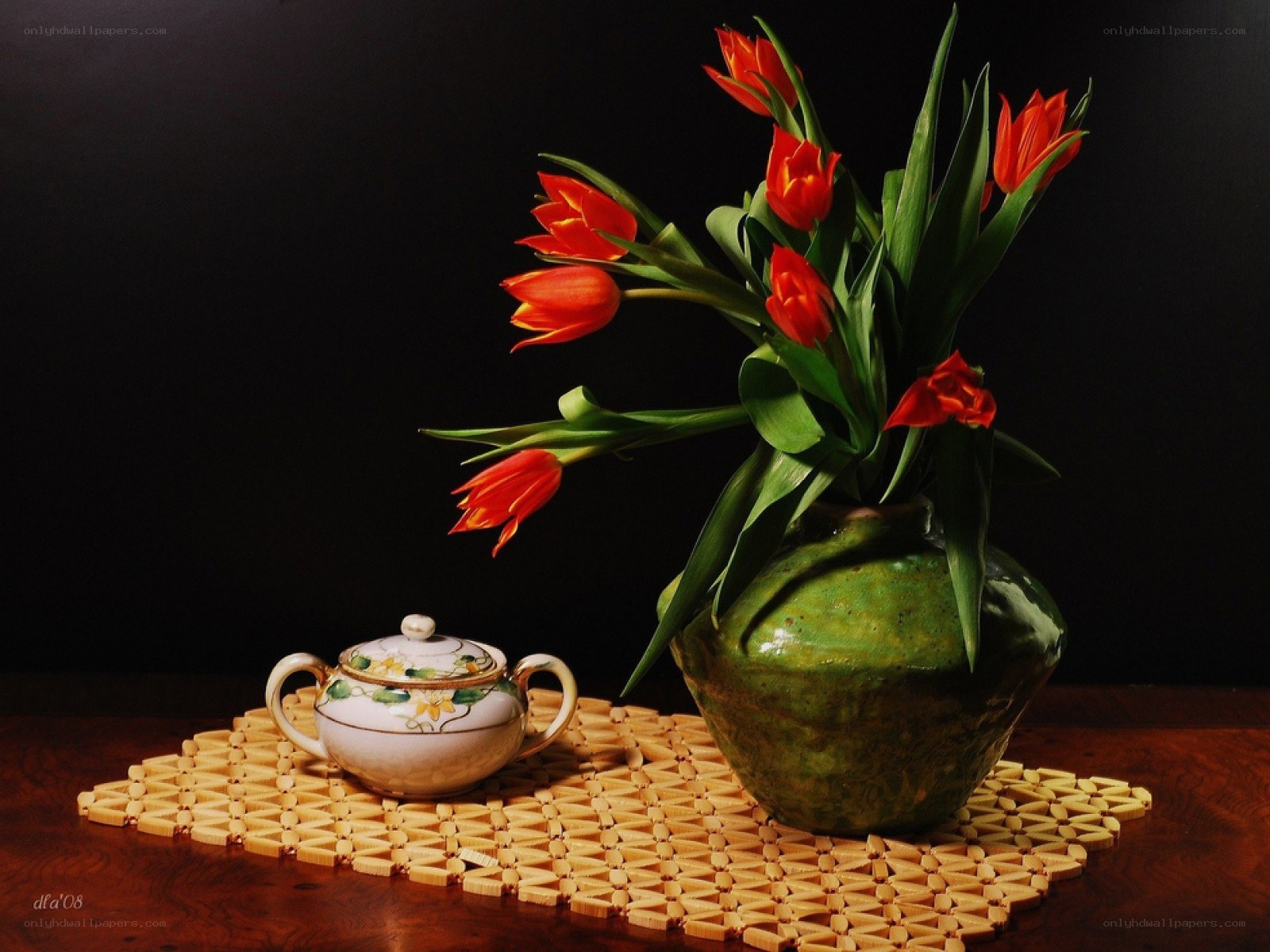 Tulips and teapot on mat