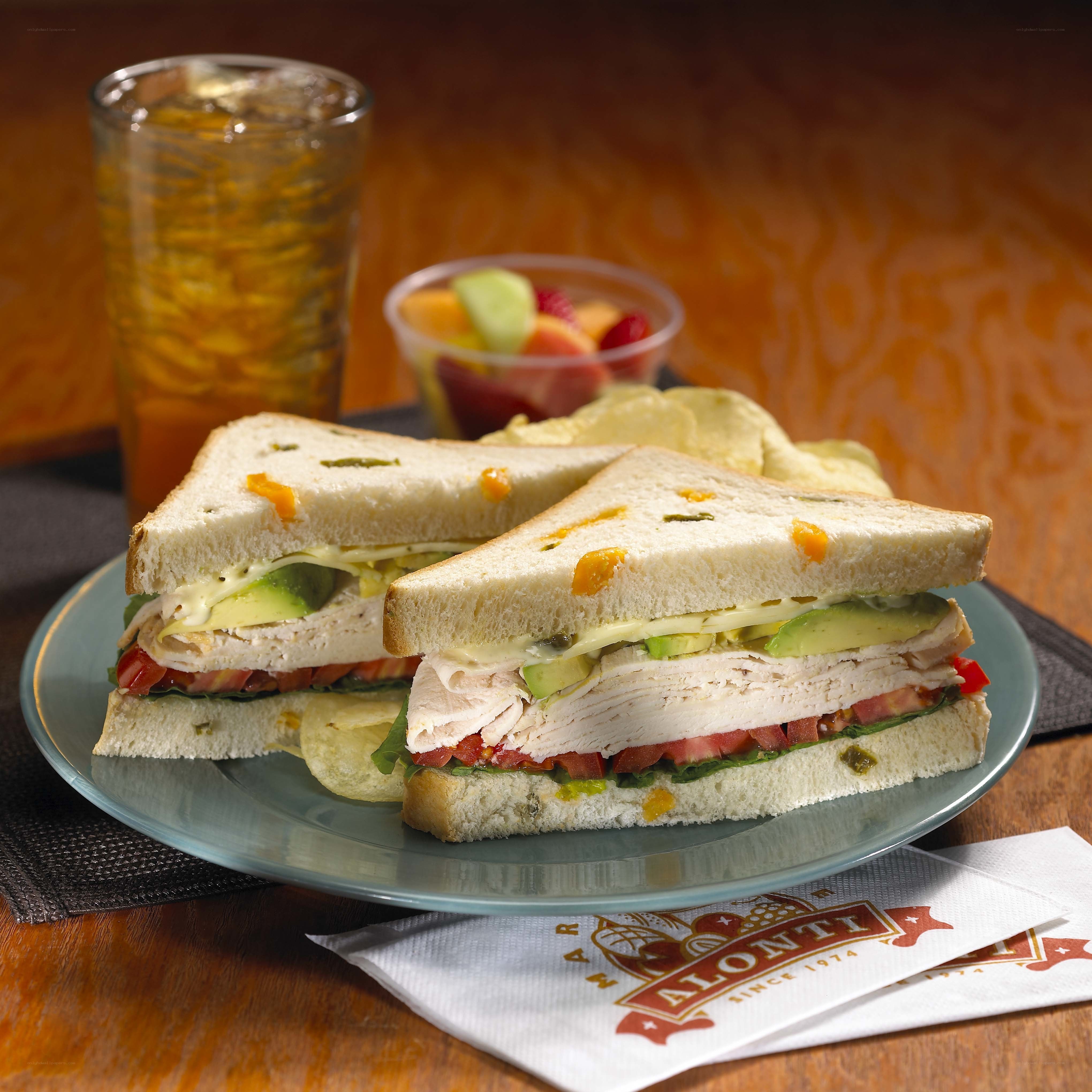 Turkey sandwich with fruit and drink