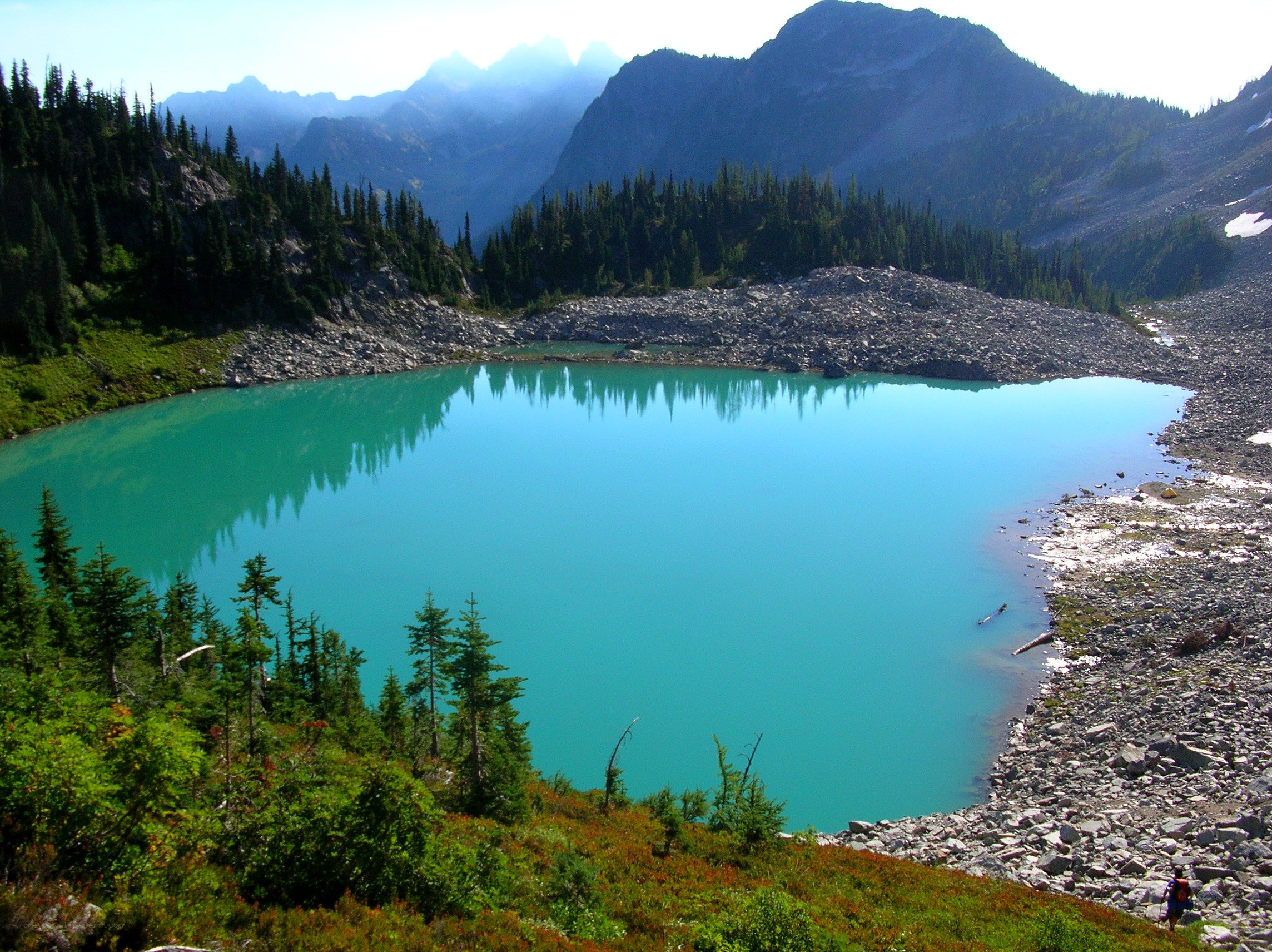 turquoise alpine lake with mountains