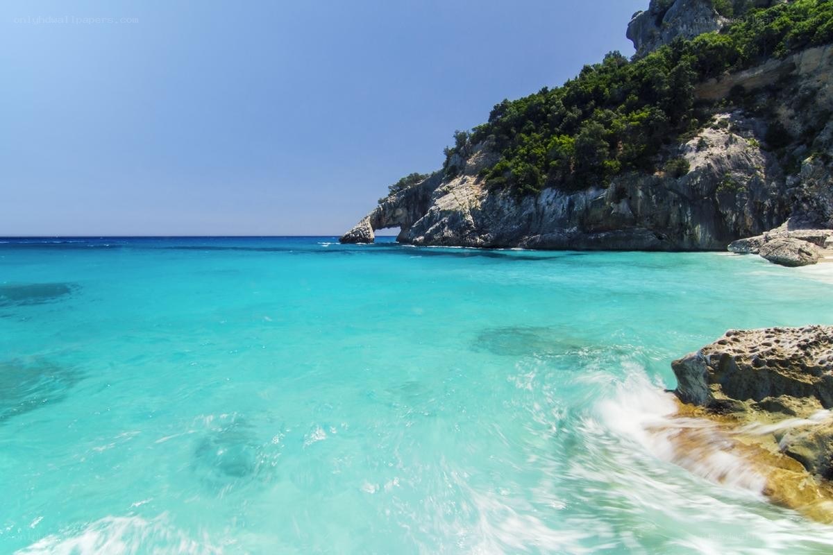 turquoise beach with rock arch