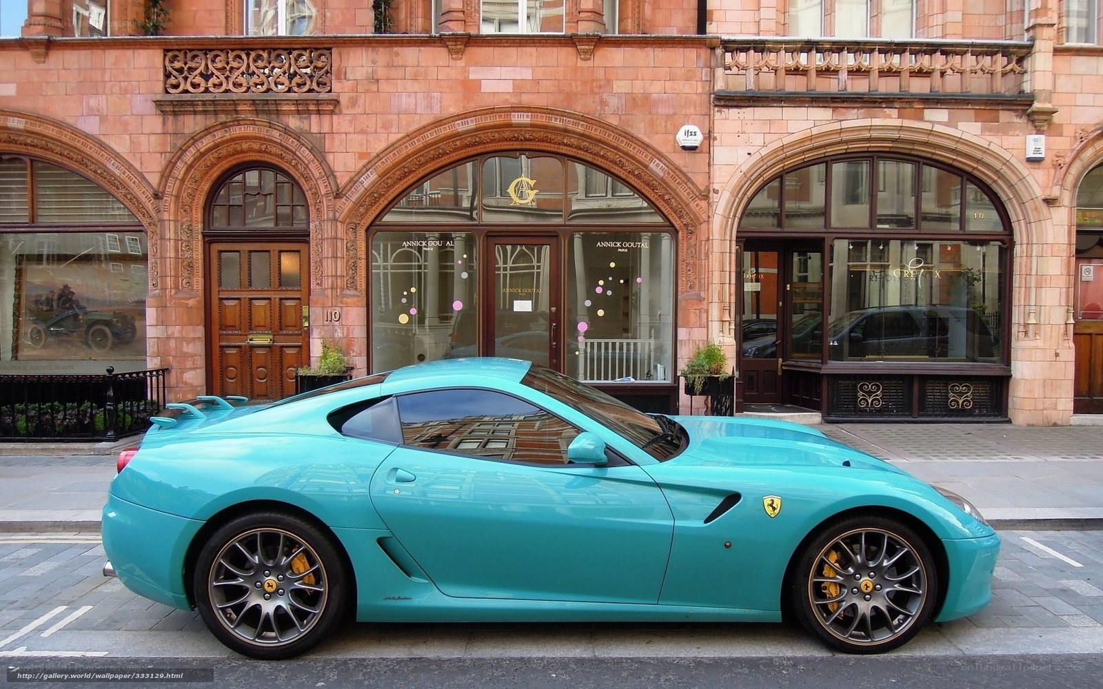 Turquoise Ferrari parked on street