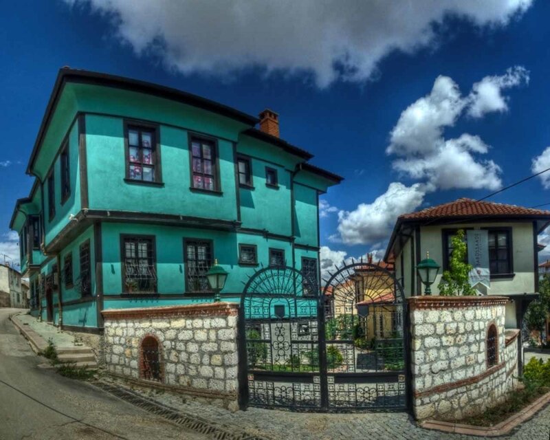 Turquoise house with stone gate