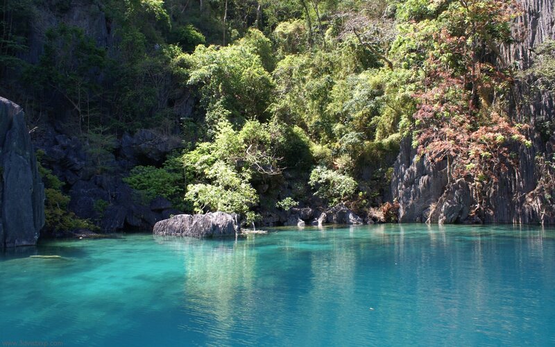 turquoise lagoon surrounded by cliffs