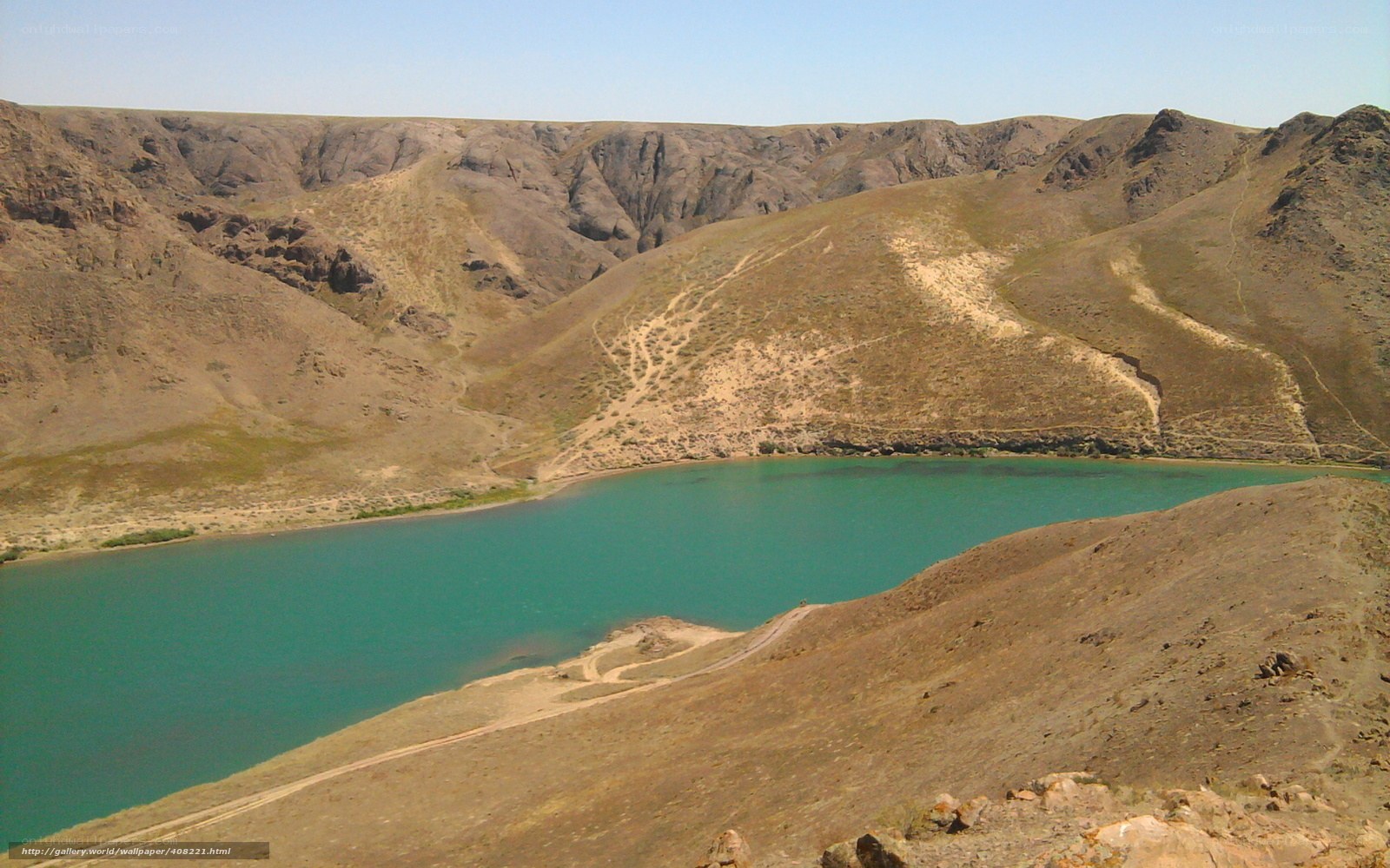 Turquoise lake in arid canyon