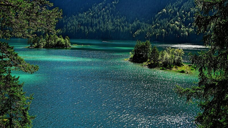 Turquoise lake with forested hills