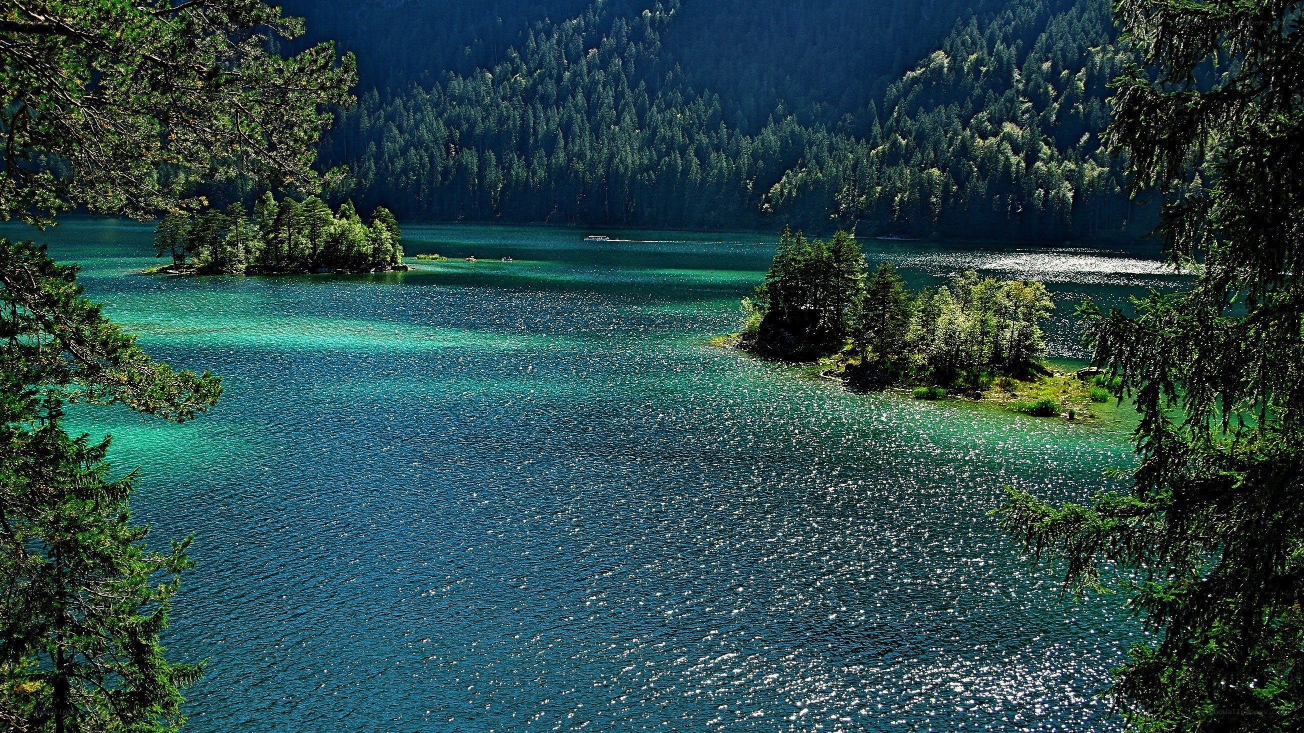Turquoise lake with forested hills