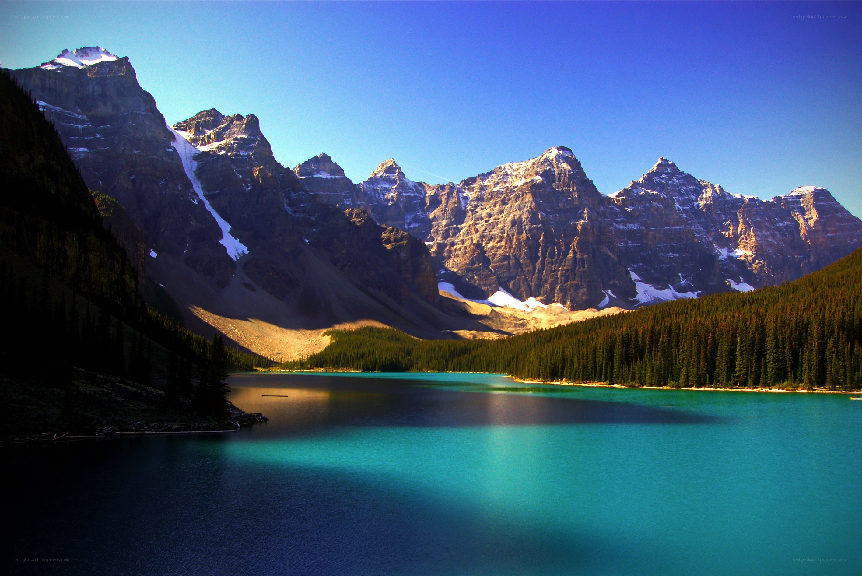 Turquoise lake with mountain peaks