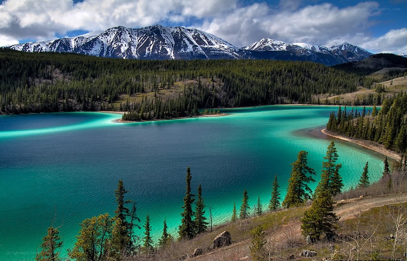 Turquoise lake with snow-capped mountains