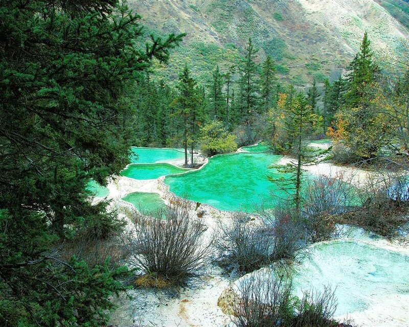 Turquoise pools in forested valley
