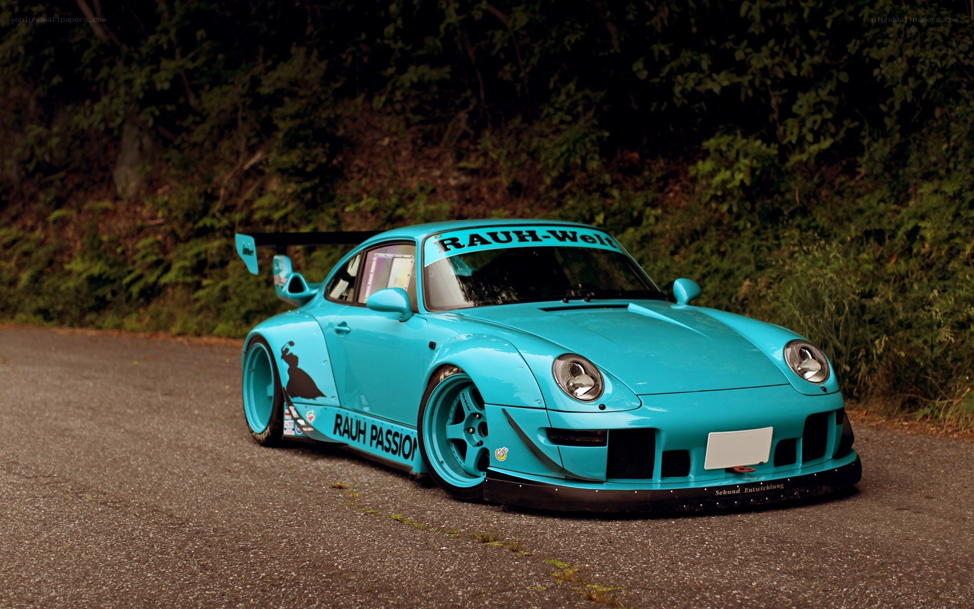 turquoise race car on road