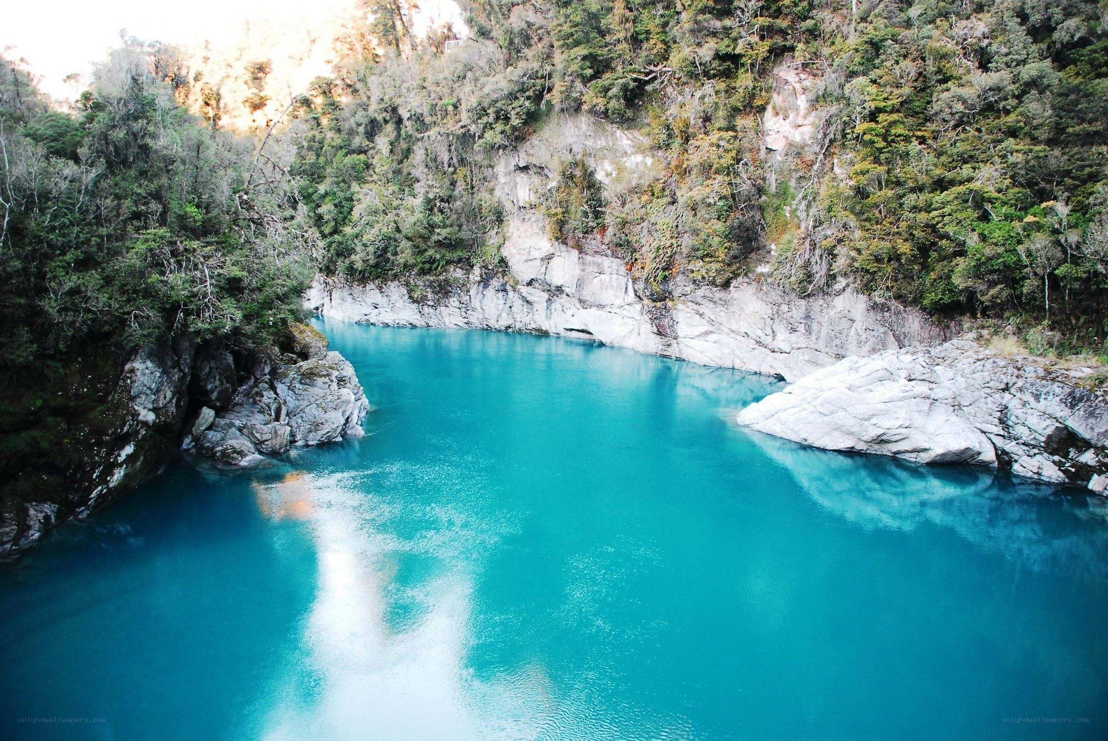 turquoise river in forest canyon
