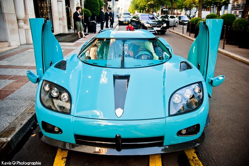 Turquoise sports car on city street