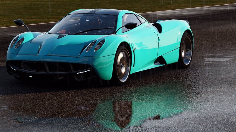 turquoise sports car on wet track