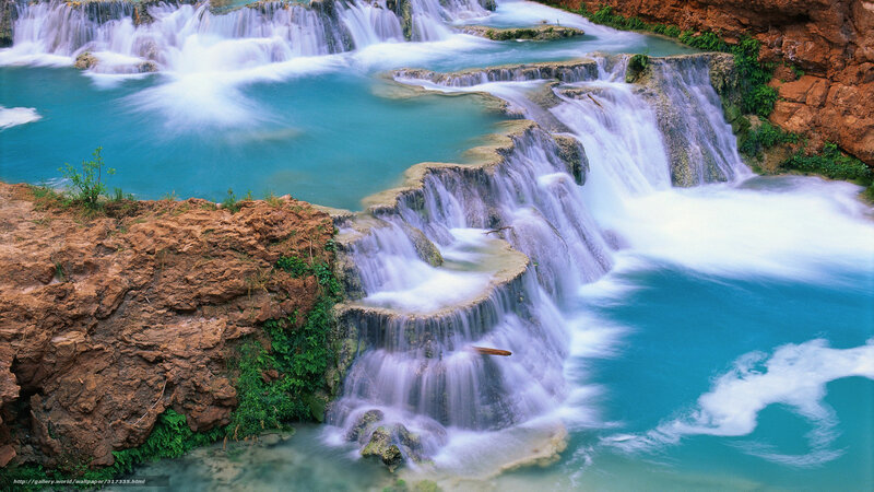 Turquoise waterfalls cascading over rocks