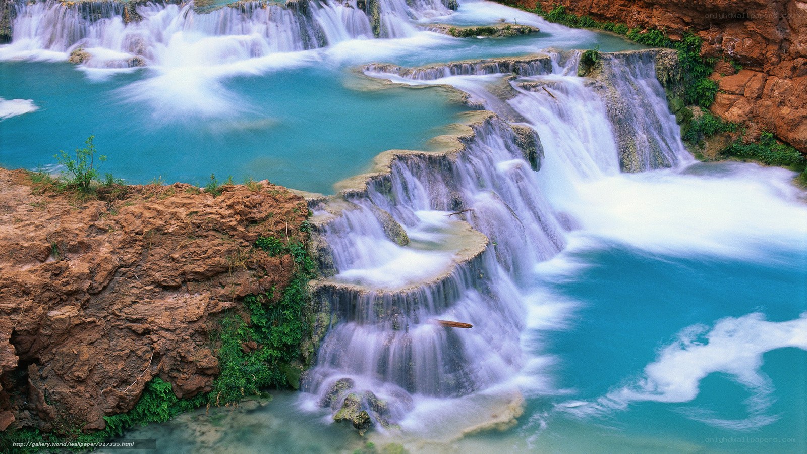 Turquoise waterfalls cascading over rocks