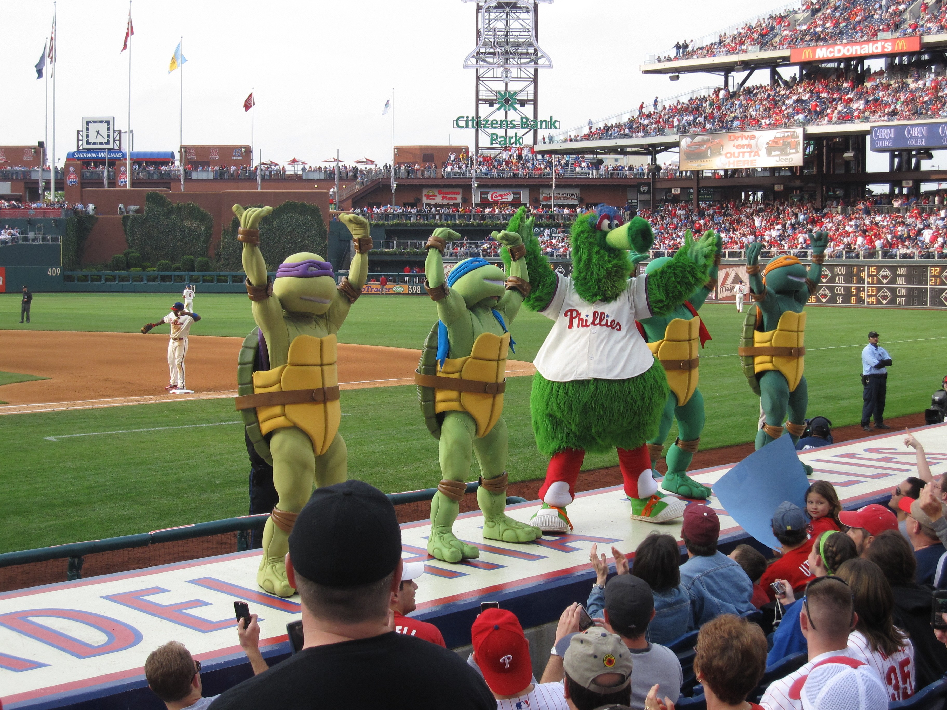 Turtles and mascot at baseball game