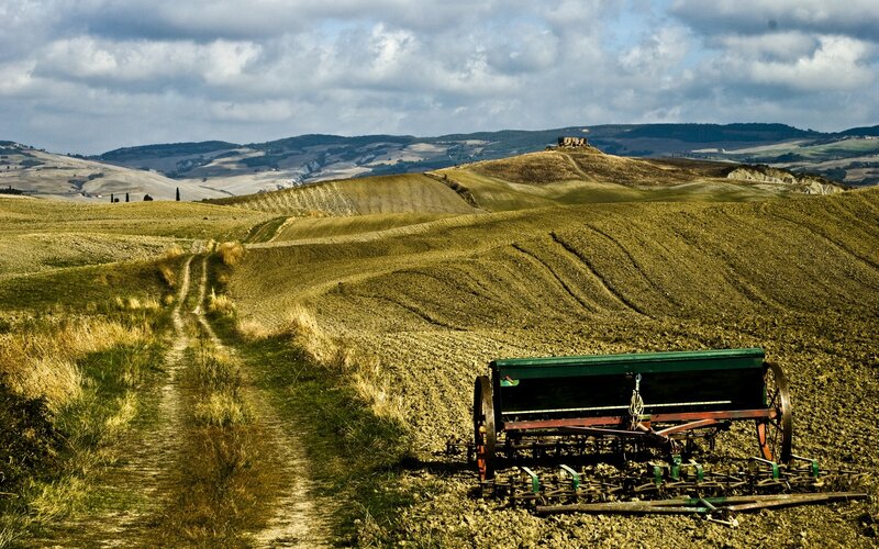 Tuscan farmland with plow