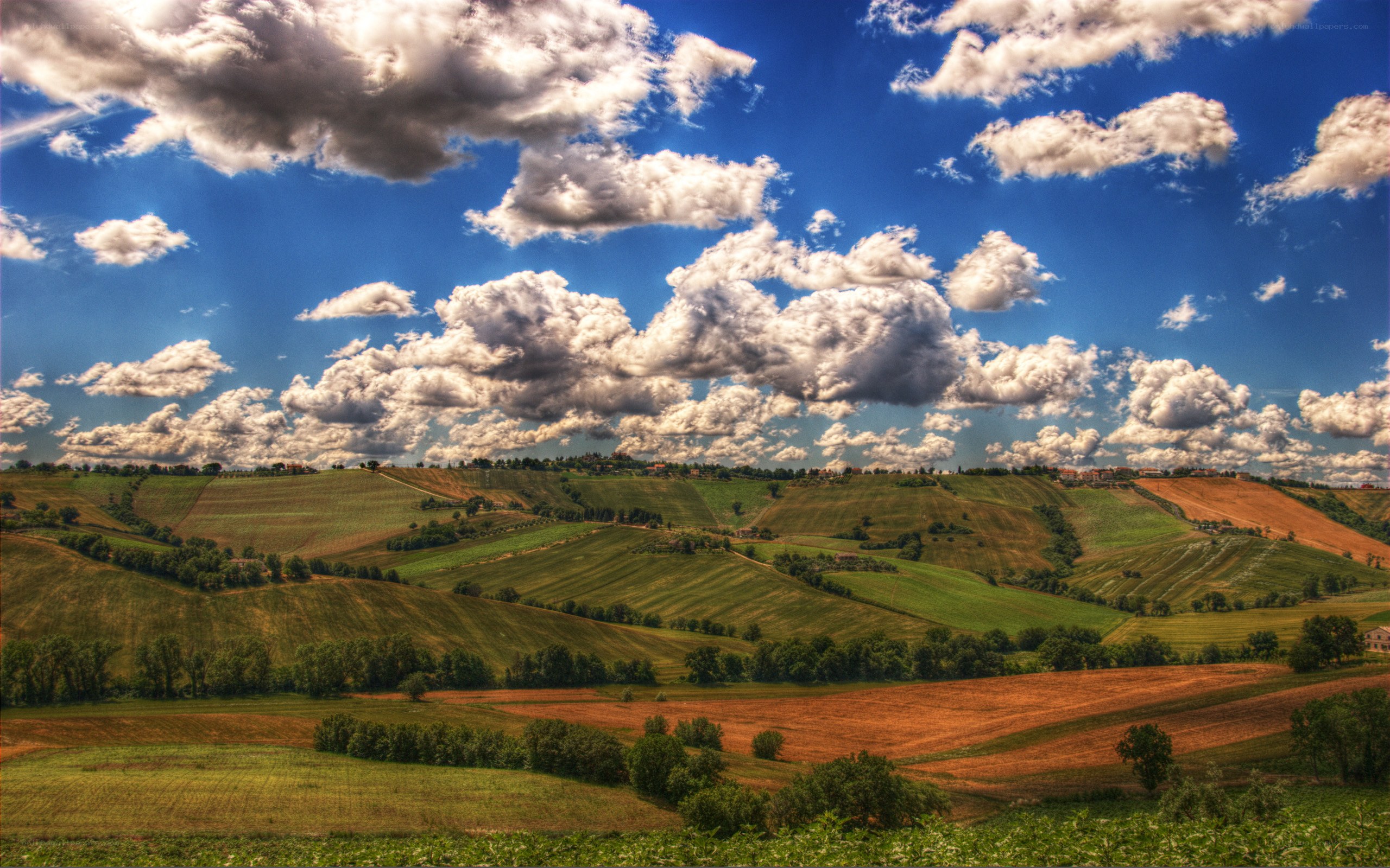 Tuscan hills under cloudy sky