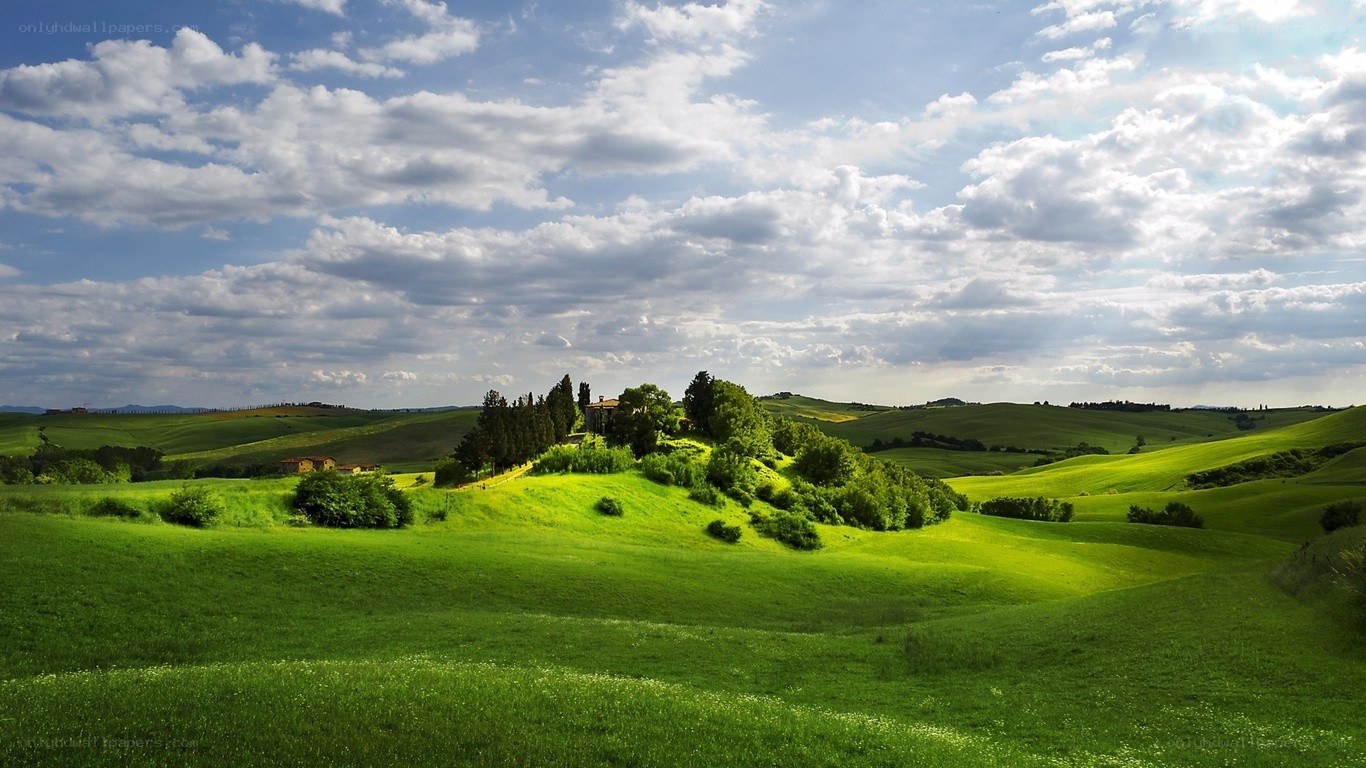 Tuscan hills under cloudy sky
