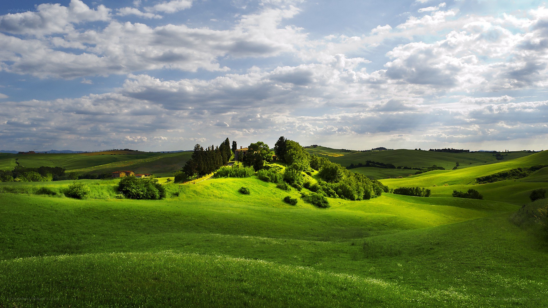 Tuscan hills under cloudy sky