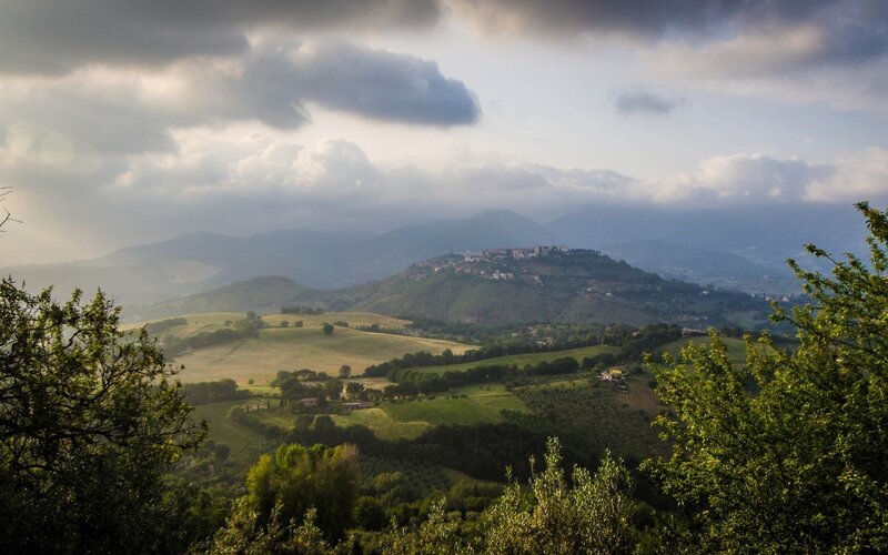 Tuscan hills under cloudy sky