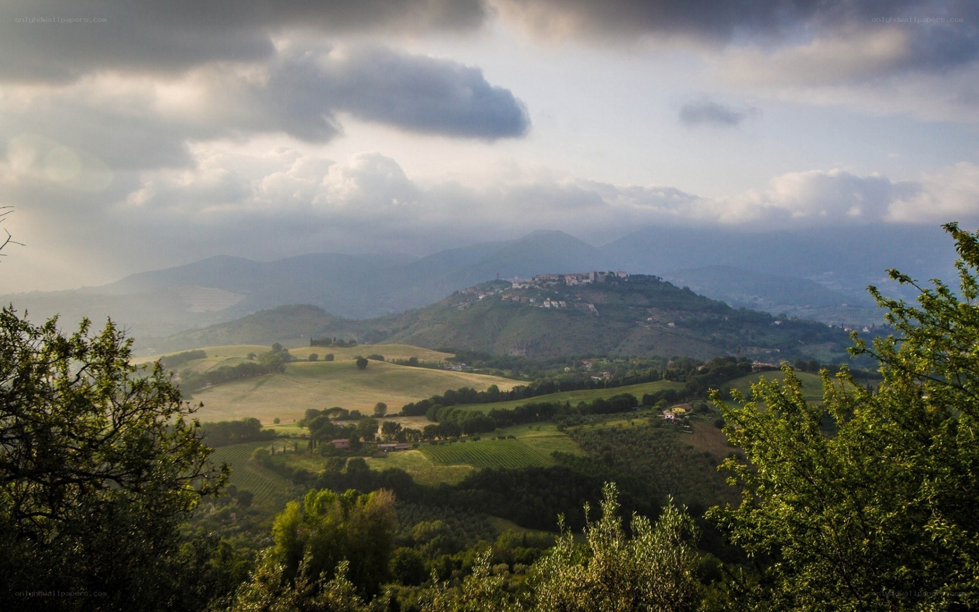 Tuscan hills under cloudy sky