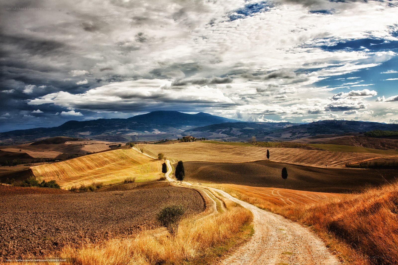 Tuscan hills under dramatic sky