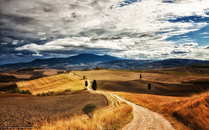 Tuscan hills under dramatic sky
