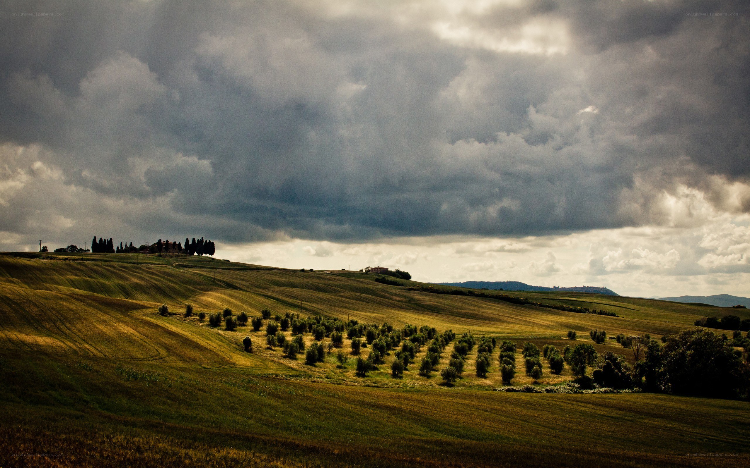 Tuscan hills under stormy sky