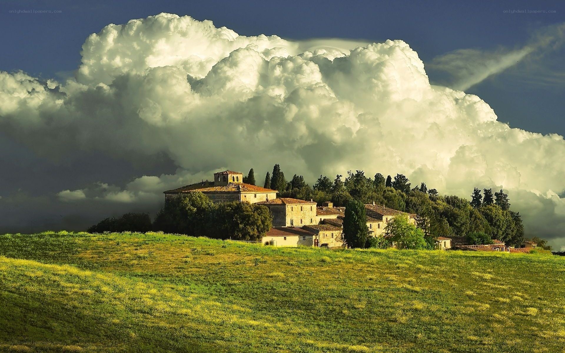 Tuscan hilltop village under storm clouds