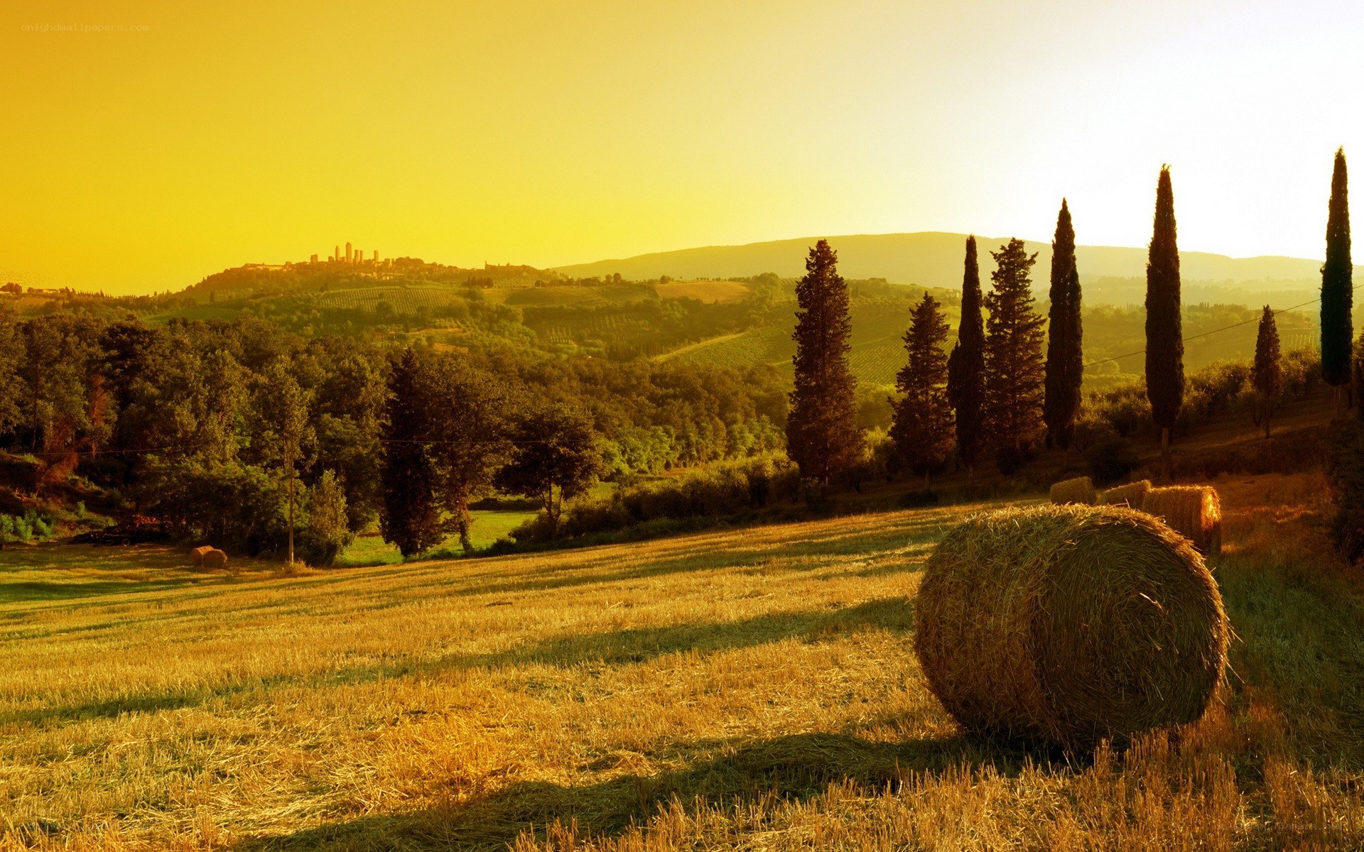 Tuscan sunset with hay bales