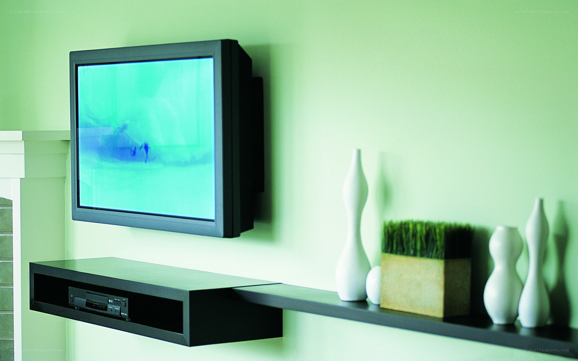 TV mounted on green wall