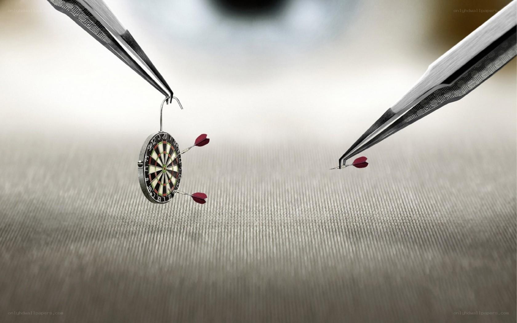 tweezers holding a dartboard
