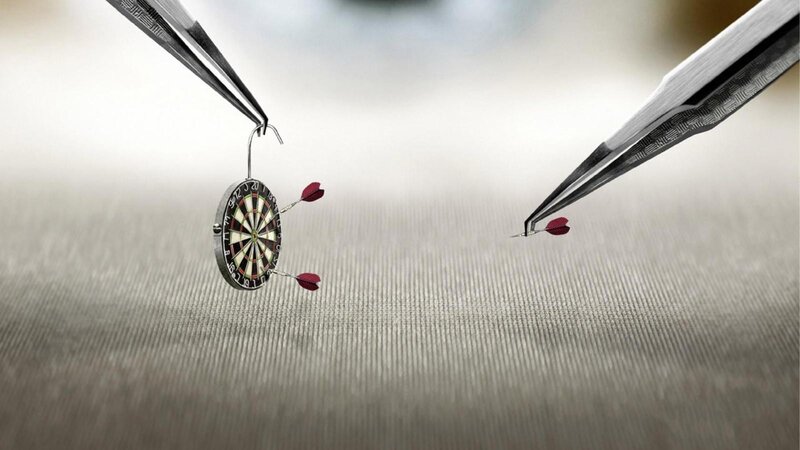 tweezers holding dartboard and darts