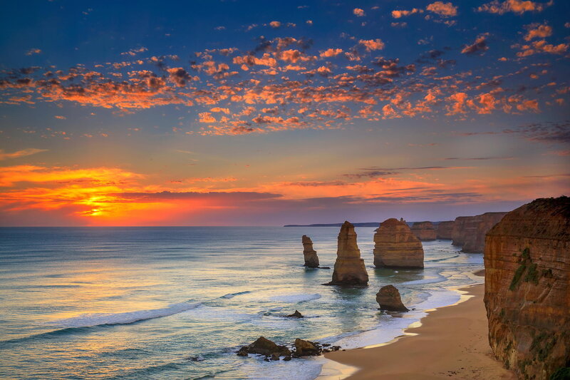 Twelve Apostles Rock Formations — Blue, Dramatic, Sunset, Photograph, Ocean, Beach