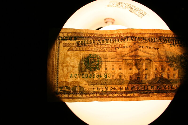 Twenty dollar bill under magnifying glass