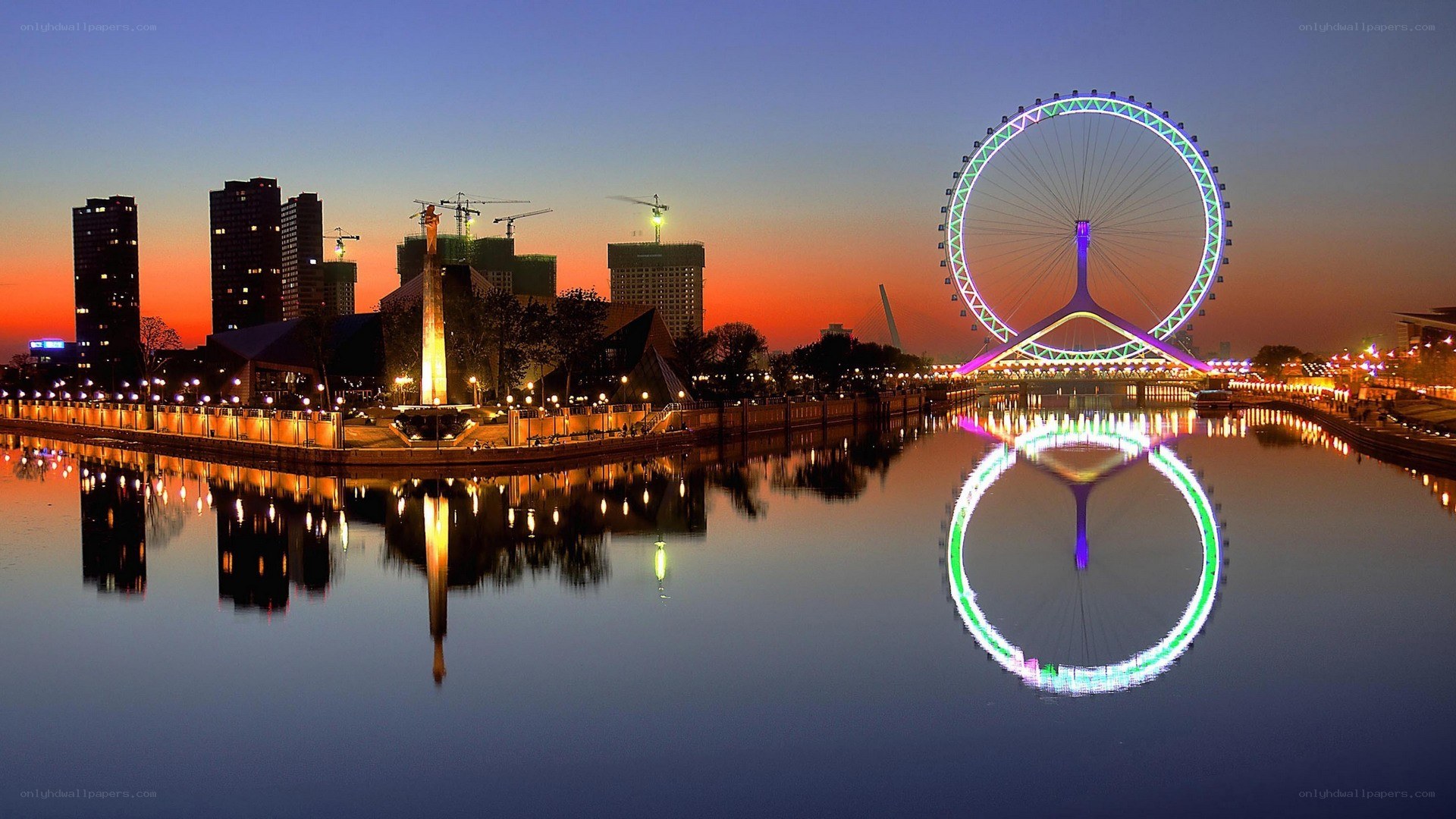 Twilight cityscape with Ferris wheel