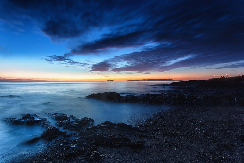 Twilight over rocky coastline