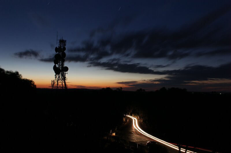 Twilight road with communication tower