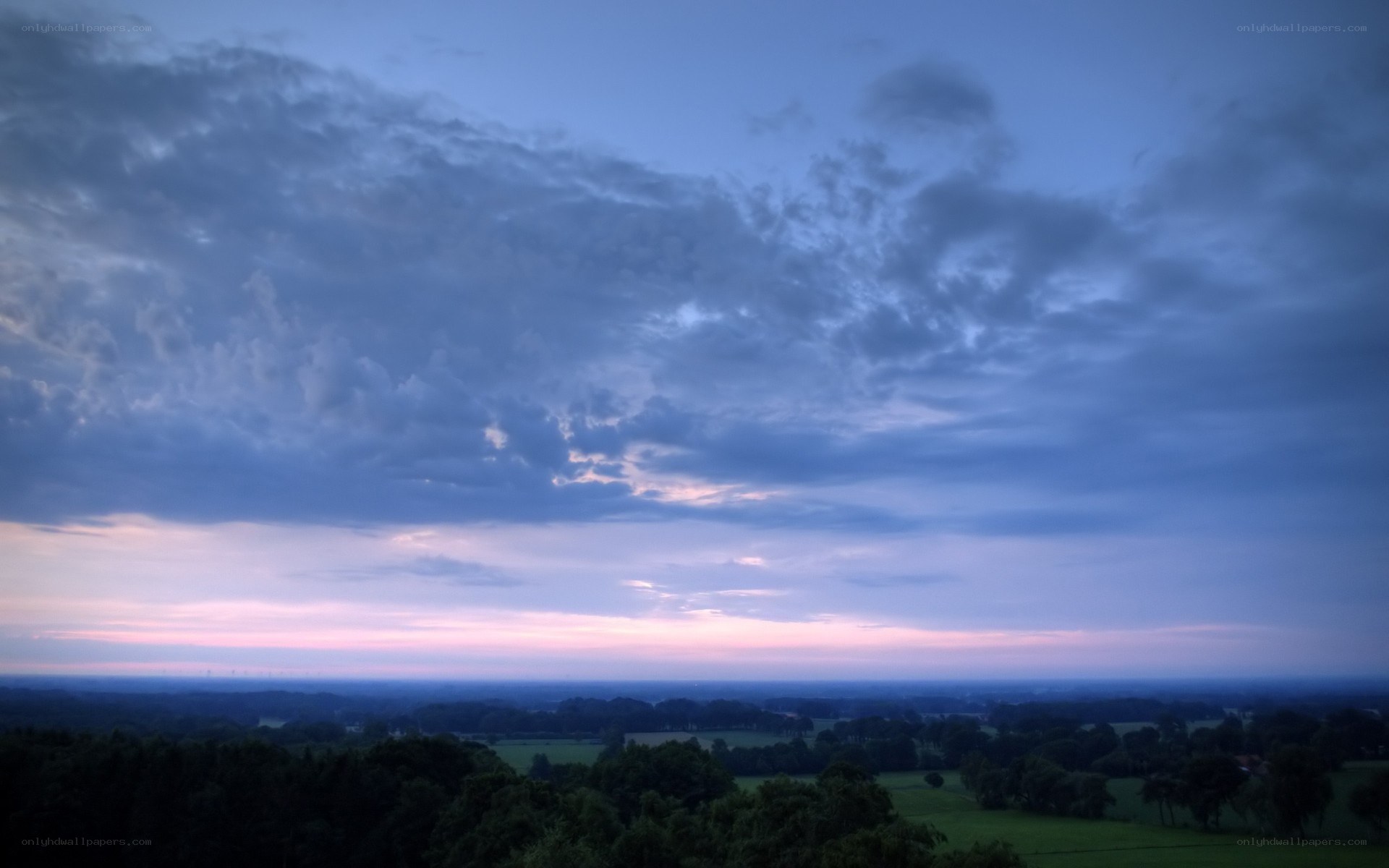 Twilight sky over green fields